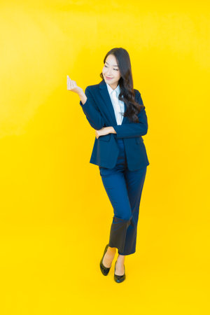 Portrait beautiful young asian woman smile with action on color backgroundの写真素材