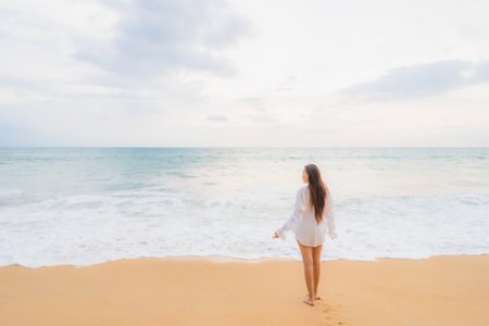 Portrait beautiful young asian woman relax leisure around outdoor beach sea ocean in travel vacationの写真素材