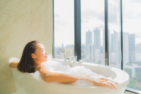 Portrait beautiful young asian woman relax and leisure in bathtub decoration in bathroom interiorの写真素材