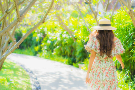 Portrait beautiful young asian woman walking with happy enjoy around outdoor garden viewの写真素材