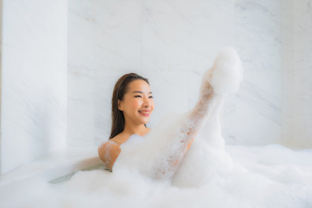 Portrait beautiful young asian woman relax enjoy in bathtub at bathroom interiorの写真素材