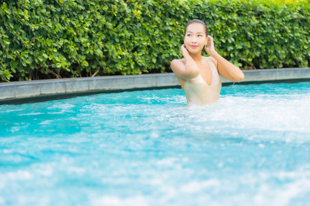 Portrait beautiful young asian woman relax smile leisure on vacation around swimming pool in resort...