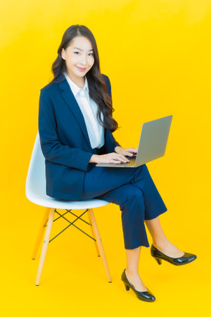 Portrait beautiful young asian woman smile with computer laptop on isolated backgroundの写真素材
