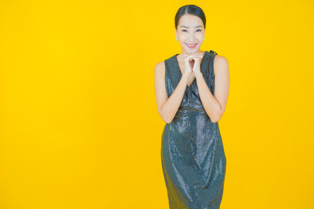 Portrait beautiful young asian woman smile with action on color backgroundの写真素材