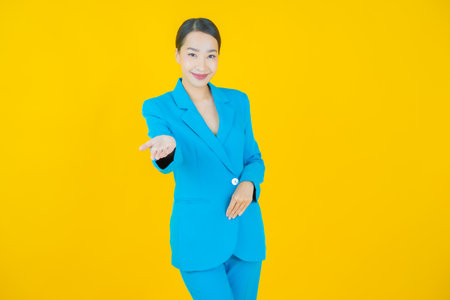 Portrait beautiful young asian woman smile with action on color backgroundの写真素材
