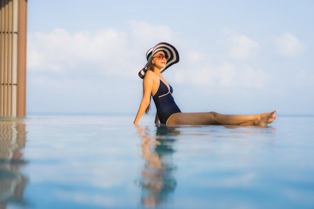 Portrait beautiful young asian woman relax around swimming pool in hotel resort for leisure in...