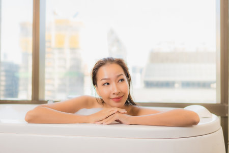 Portrait beautiful young asian woman relax enjoy take a bath at bathtub in bathroom interiorの写真素材