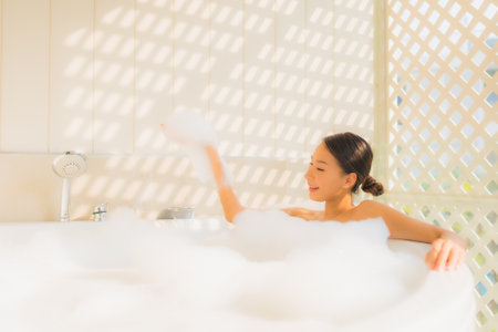 Portrait young asian woman relax take a bath in bathtub for spa conceptの写真素材