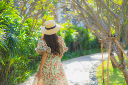 Portrait beautiful young asian woman walking with happy enjoy around outdoor garden viewの写真素材