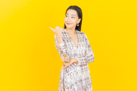 Portrait beautiful young asian woman smile with action on color backgroundの写真素材