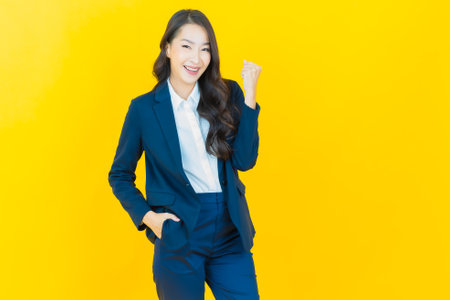 Portrait beautiful young asian woman smile with action on color backgroundの写真素材