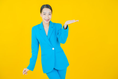 Portrait beautiful young asian woman smile with action on color backgroundの写真素材