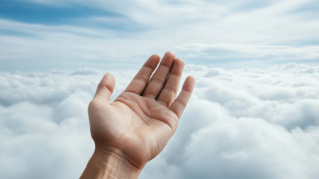 A giant hand reaching out from clouds evokes dreamlike feelingの素材