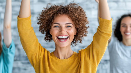 A Happy woman celebrating success with friends in bright settingの素材