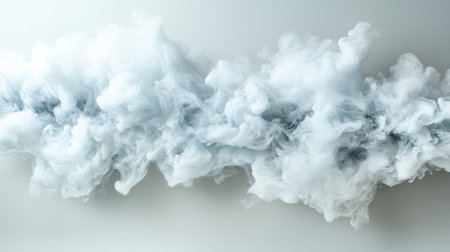A swirling cloud of white smoke against light background creates dreamy atmosphereの素材