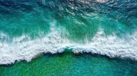 A mesmerizing aerial view of ocean showcasing swirling waves and vibrant colorsの素材