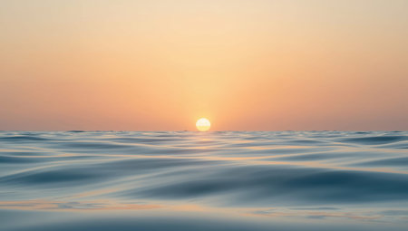 Serene sunset over calm sea with golden horizon and soft pastel skyの素材