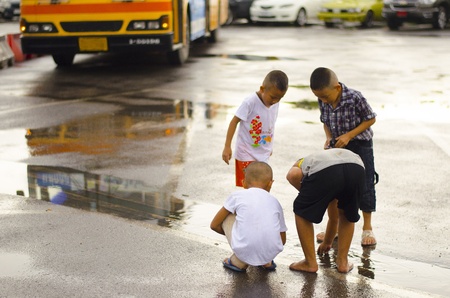 Four Thai kids are enjoy after rainのeditorial素材