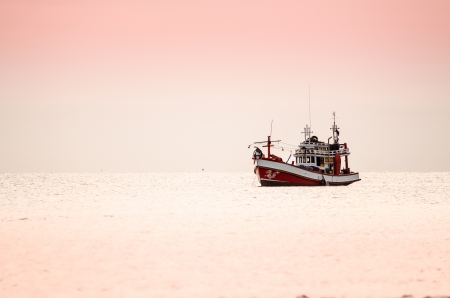 Ships at sea in sunriseの写真素材