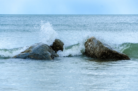 waves breaking on the shore with sea in the morningの写真素材