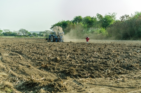 Blue Tractor Plowing in duskの写真素材