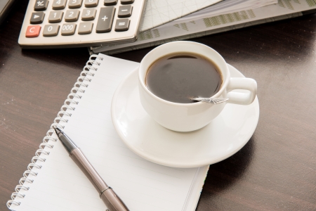 Coffee and the calculator and penの写真素材