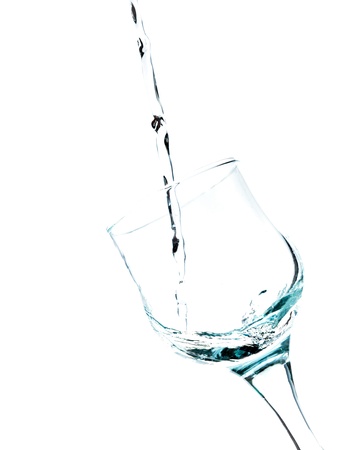 Water splashing in a glass, isolated on white , verticalの写真素材