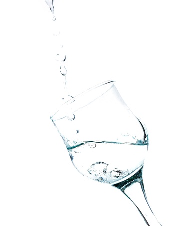 Water splashing in a glass, isolated on white , verticalの写真素材