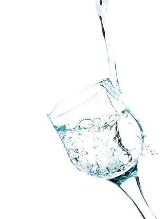 Water splashing in a glass, isolated on white , verticalの写真素材