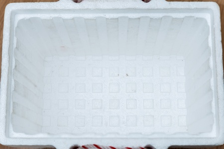 open polystyrene storage box on wood backgroundの写真素材