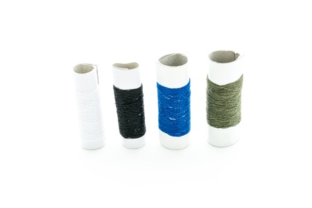 Spool of thread and needle on white backgroundの写真素材