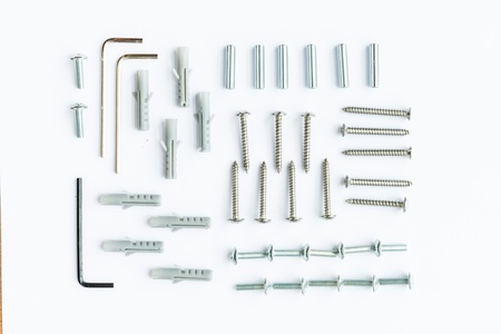 Close-up of various steel nuts and bolts on white backgroundの写真素材