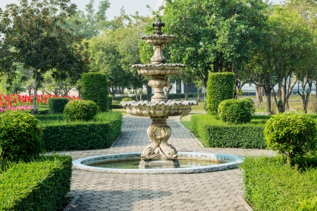 road in a public park lead to the white fountainの写真素材
