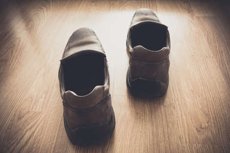 brown shoes on wood background view from backの写真素材
