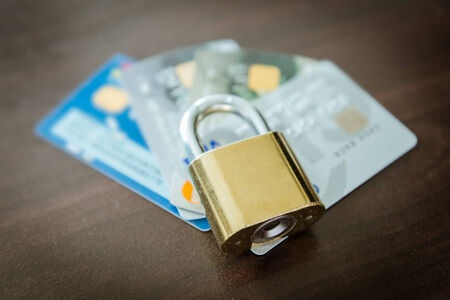 Credit cards and lock, business security on wooden backgroundの写真素材