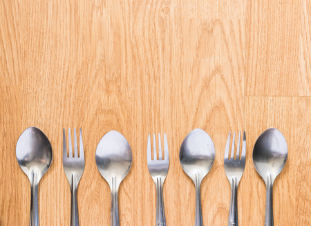 spoon and fork on wood table background