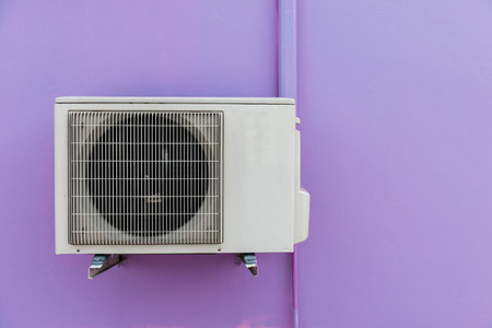 Air compressor on purple wallの写真素材