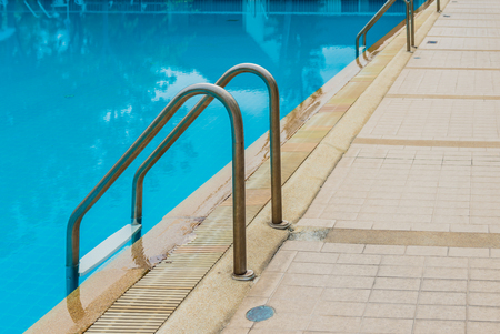 Swimming pool with stair at hotel close upの写真素材