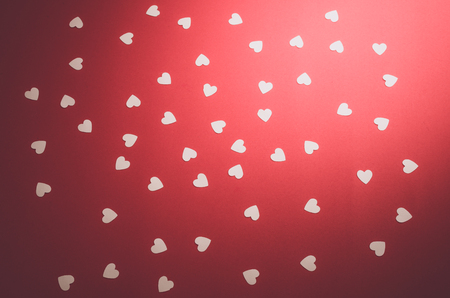 white little hearts on red backgroundの写真素材