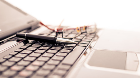 Modern business desk with laptop, pen and glasses. Modern business conceptsの写真素材