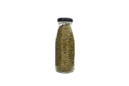 rice seeds in a glass bottle on white background