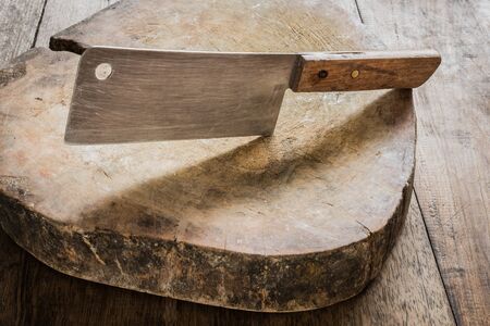 Knife on a wooden butcher on old wooden backgroundの写真素材