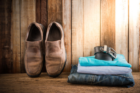 Still life with casual man on wooden tabletop against grunge wall. vintage toneの写真素材