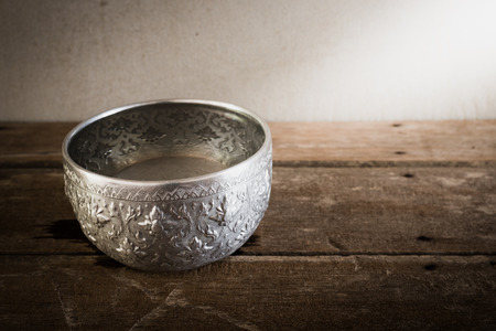 Still life art photography on vintage water in silver bowlの写真素材