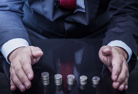 businessman protected money coins. saving and insurance conceptの写真素材