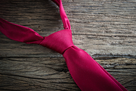 closeup red necktie on wooden tableの写真素材