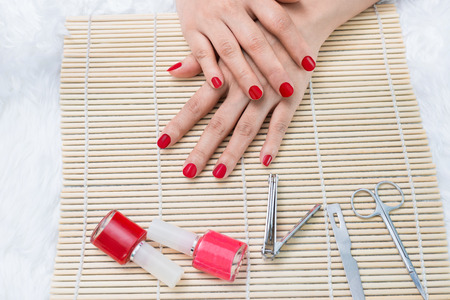 Manicure - Beautiful manicured woman's nails with red nail polishの写真素材
