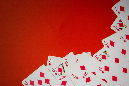 Deck of cards used as a corner on  red backgroundの写真素材