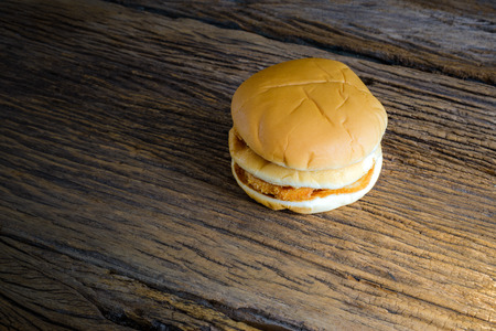 still life of chicken hamburger on top wooden table