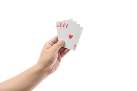 Playing cards in hand isolated on white background with clipping pathの写真素材